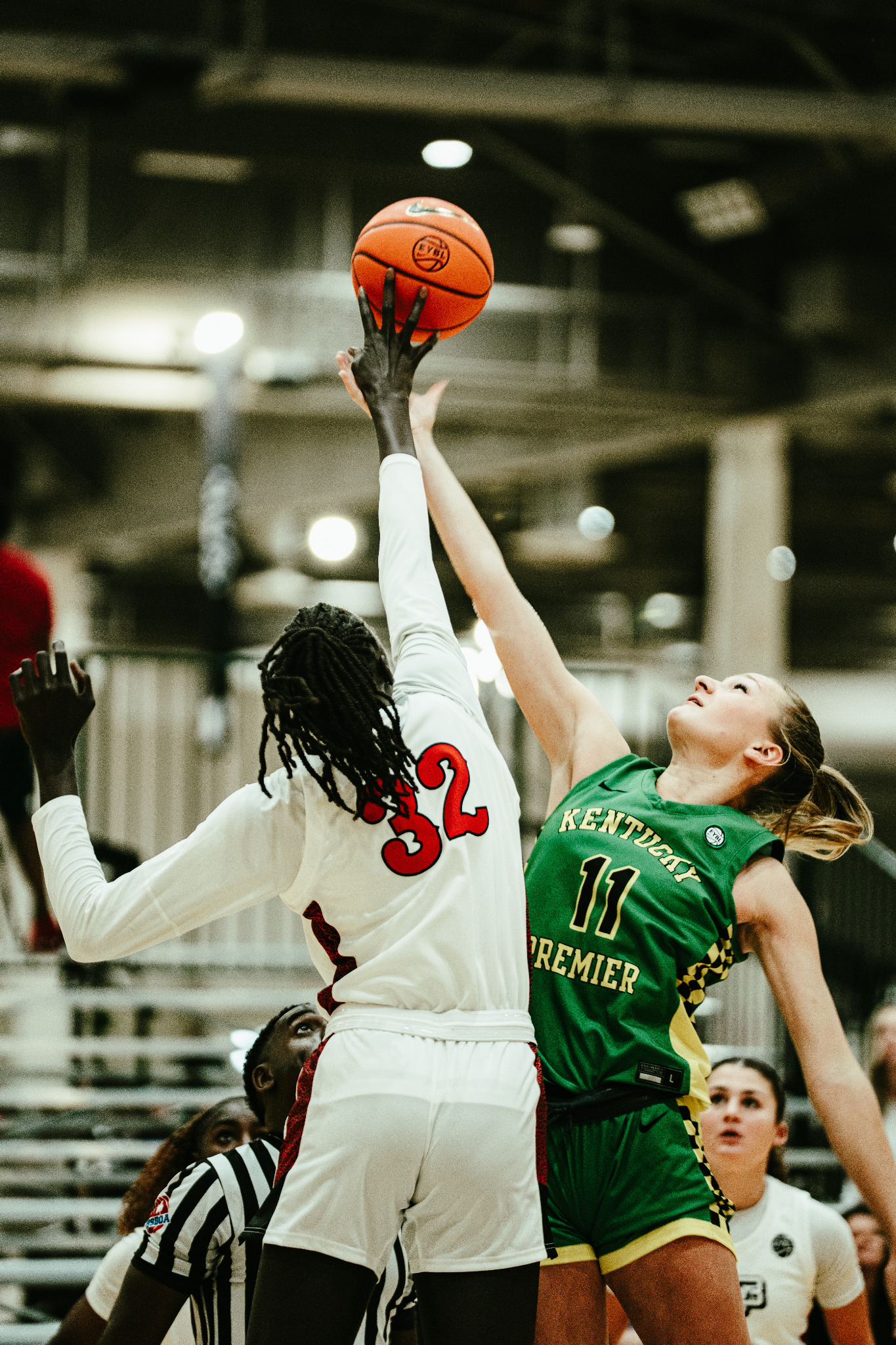 Female basketball players competing for a rebound at an exposure event