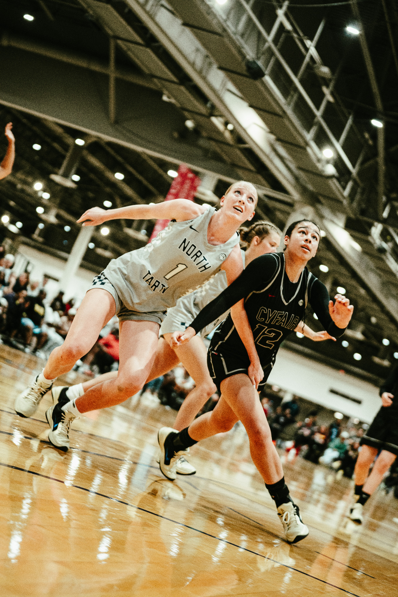 Female basketball players competing for possession during a tournament